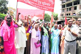 Women workers of a tea estate hold a demonstration in support of their demands in Dehradun on Tuesday