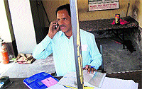 A clerk sits in a shack at the Green Tax Barrier