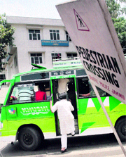 Paying no heed to traffic rules, a mini-bus stops at a zebra crossing to board passengers at the busy Bikram Chowk in Jammu on Tuesday.