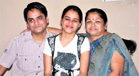 Urvashi Aggarwal, who stood first in commerce stream, with her parents in Jammu on Tuesday.