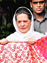 UPA chairperson Sonia Gandhi holds a chadar before sending it to the shrine of Khwaja Moinuddin Chishti in Ajmer during his ongoing 800th Urs, in New Delhi on Tuesday
