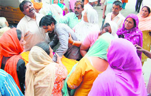 Wailing relatives of the victims outside Guru Nanak Dev Hospital; and (below) the three survivors in a hospital in Amritsar on Wednesday. 