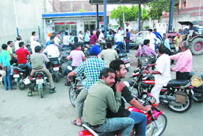 Two-wheeler drivers queued up at this fuel station at Teenkoni Chowk to get the tanks of their vehicles filled.