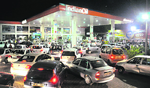 A rush of motorists at the Sector 28 petrol station in Chandigarh following a steep hike in fuel prices on Wednesday.