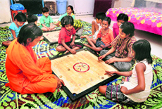 Children shifted from Rohtak shelter home play carrom board at a Child Shelter in Chhachhrauli, near Yamunanagar.