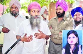 The father of Prabhjot (inset) along with fellow villagers at the Civil Hospital in Jalandhar on Wednesday