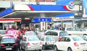 Queues of vehicles can be seen at a filling station soon after the news of the hike in petrol prices spreads in Jalandhar on Wednesday evening