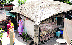 Kashmiri Pandits outside their makeshift house at a migrant camp in Jammu where they have been living for the past 18 years