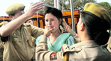 Police personnel measure the height of a candidate during a recruitment rally in the Nagrota area of Jammu on Wednesday