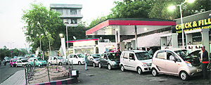 Vehicles queue up at a petrol station as the government announced a substantial hike in the price of petrol, which came into effect from midnight, in Jammu on Wednesday