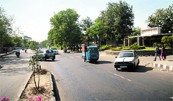 In the absence of speed humps, a car emerges out of the Jammu University gate, narrowly missing an auto-rickshaw