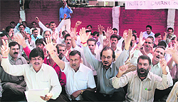 Members of the National State Government Employees Federation stage a protest in Jammu on Wednesday