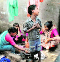 A child and women mourn the death of a boy after a powerful blast at Kareli locality in Allahabad on Wednesday.