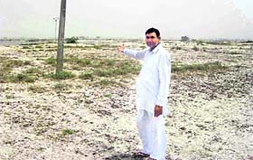A farmer shows his barren field at Harnam Chand village in Fazilka