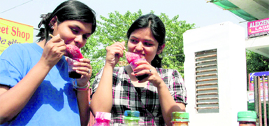Girls enjoy ice-candies as the temperature in Dehradun reached 40 C