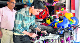 A youth selects a bicycle as the sales of these spiralled owing to a hike in petrol prices in Haridwar on Thursday.