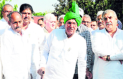 INLD chief Om Prakash Chautala (centre) with other party leaders comes out of Haryana Raj Bhawan after giving a memorandum to the Governor in Chandigarh on Thursday