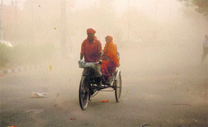 A rickshaw-puller braves a dust storm that hit Karnal recently.