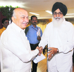 Punjab Chief Minister Parkash Singh Badal with Union Minister of Power Sushil Kumar Shinde in New Delhi on Thursday