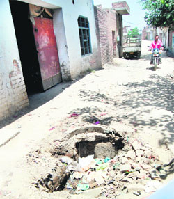 A big pothole poses danger to the Haripura locality residents in Ward 56 in Amritsar. 