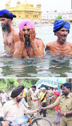 Devotees take a dip in the holy sarovar at the Golden Temple on the Martyrdom Day of Guru Arjan Dev; and (below) CRPF officials and jawans distribute sweetened water in Amritsar on Friday. 