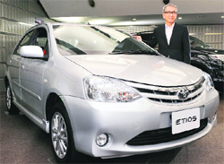 Toyota Motor executive vice-president Yukitoshi Funo poses by the Japanese giants global compact car Etios at Toyota's Tokyo office