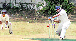 A batsman plays a defensive shot in a match in the 30th All-India Uttarakhand Gold Cup Cricket Tournament played at Rangers' College ground in Dehradun on Thursday