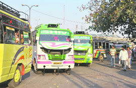 Minibus drivers jostle for space on a road, in violation of the traffic norms, in Jammu.