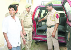 The man held for smuggling drugs being led away by the police in Jammu on Friday. 
