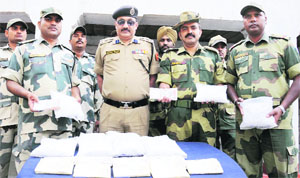 BSF officials with the seized heroin near Rorawala in Amritsar