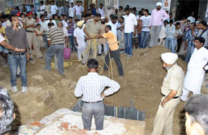 Rescue operation to find out the workers in progress at Lal Singh Basti in Bathinda on Saturday. 