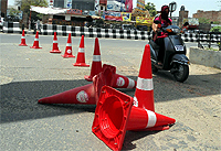 The plastic boulders, installed to demarcate lanes for vehicles, have fallen and are causing accidents on city roads