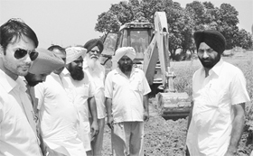 Mohali Deputy Commissioner Varun Roojam (extreme left) inspects an anti-encroachment drive at a village in Dera Bassi on Saturday.