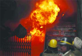 Firefighters douse a fire that engulfed a factory in New Delhi on Saturday