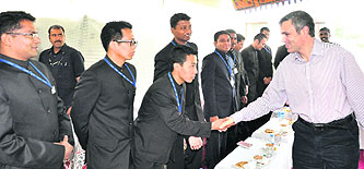 Chief Minister Omar Abdullah shakes hand with an IFS probationer during an interactive session in Srinagar on Saturday.