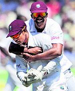 West Indies Darren Sammy and Denesh Ramdin celebrate after Alastair Cooks wicket during the second Test at Trent Bridge on Saturday