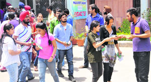 PUSU activists give helpline numbers to candidates at the University Institute of Legal Studies on the campus