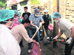 Akshat Gupta ( centre), District Magistrate, Almora, participates in a clealiness drive in Almora town on Sunday. 