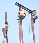 PDD linesmen atop poles repair transmission lines without any safety equipment in Jammu.