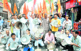 Shiv Sena activists protest against the PHE and PDD Department for irregular water supply and unscheduled power cuts in Jammu on Sunday.