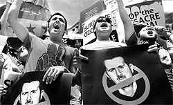 Demonstrators protest in front of the Syrian consulate in Istanbul on Sunday against the regime of Syrian President Bashar al-Assad