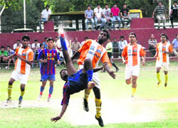 A player hits a pedal kick in a match in the Narendra Kharola Memorial All-India Football Tournament in Dehradun on Monday. 