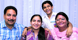 Parul Kalia of Swami Sant Dass School who scored 98 per cent marks in the CBSE Class XII exams with her family in Jalandhar on Monday.
