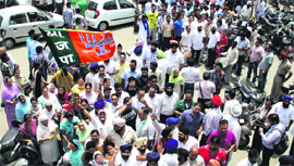Supporters of a BJP candidate outside the DC office during fling of nomination papers for MC elections in Jalandhar on Monday.