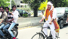 SAD candidate from Ward 50 pedalling on cycle to file his nomination papers.