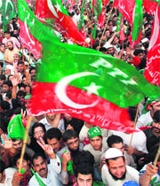 Activists of the Pakistan Tehreek-e-Insaaf wave party flags in Rawalpindi.