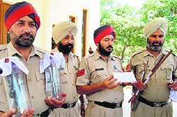 policemen show weapons seized from the accused in Amritsar on Tuesday