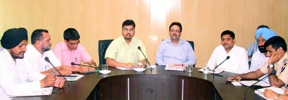 Poll officials discussing election related issues with the candidates of political parties during a meeting held at Zila Parishad in Bathinda on Tuesday. 