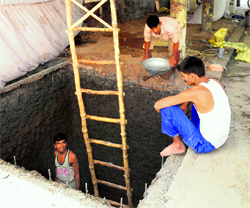 Workers construct a water tank adjoining Paul Dhaba at Sector 28 in Chandigarh.