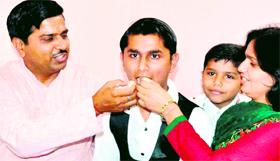 Lokesh Bharadwaj,who topped Haridwar with 91 per cent in class X, with his parents in Haridwar on Tuesday.